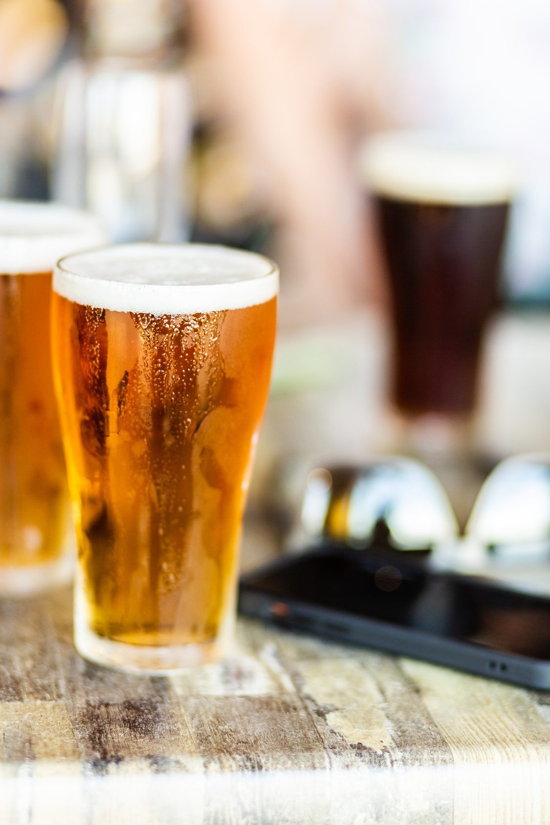 Alcoholic drinks – cold beers sitting on bench at a party